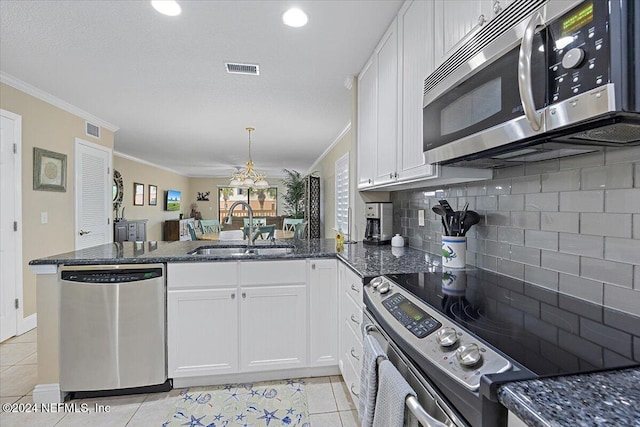 kitchen featuring light tile patterned floors, white cabinetry, sink, and appliances with stainless steel finishes