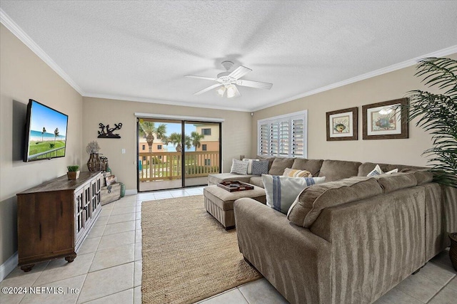 living room featuring a textured ceiling, ornamental molding, and light tile patterned flooring