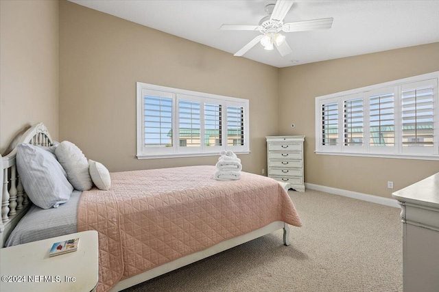 bedroom featuring multiple windows, ceiling fan, and carpet