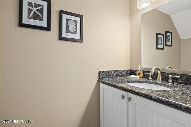 6100 A1A S Unit 419, Saint Augustine, FL 32080 - bathroom featuring vanity and lofted ceiling
