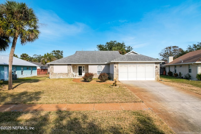 ranch-style home with a garage and a front lawn