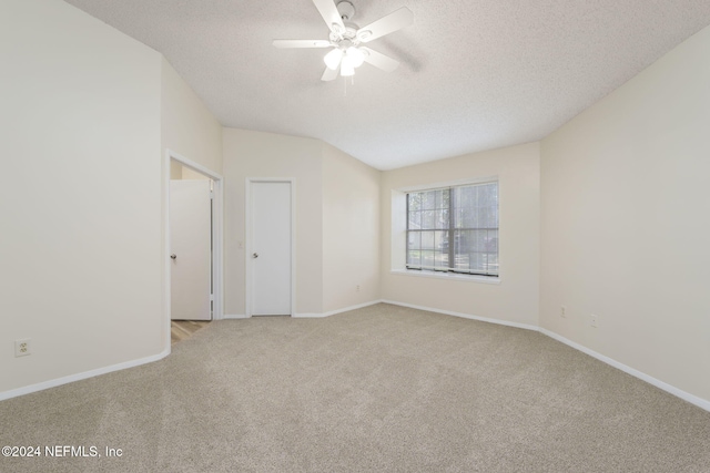 unfurnished room featuring light carpet, ceiling fan, and a textured ceiling