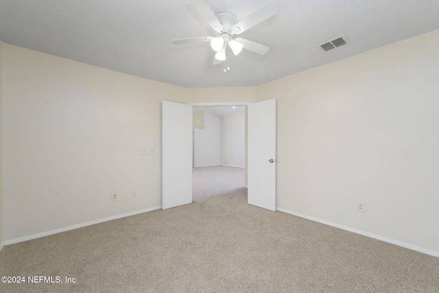 unfurnished room featuring light colored carpet and ceiling fan