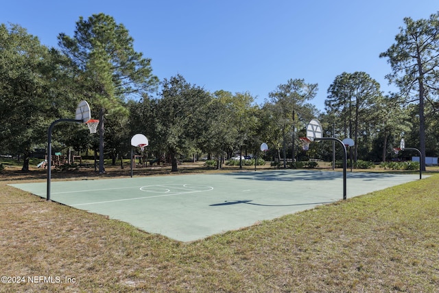 view of sport court featuring a yard