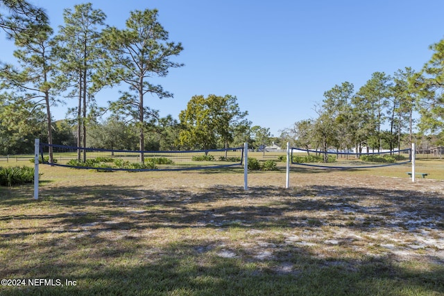 view of community with a rural view and volleyball court