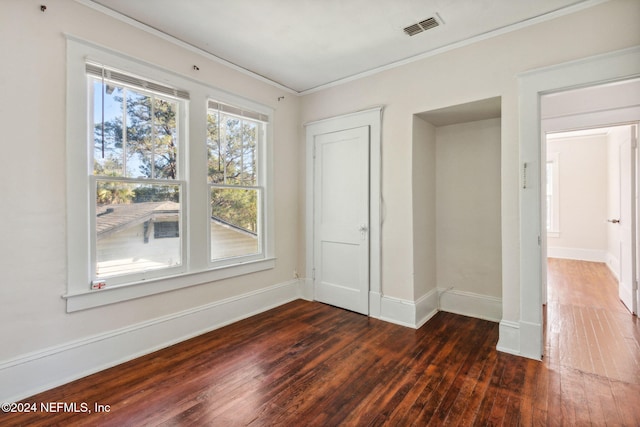 unfurnished bedroom with dark hardwood / wood-style floors and ornamental molding