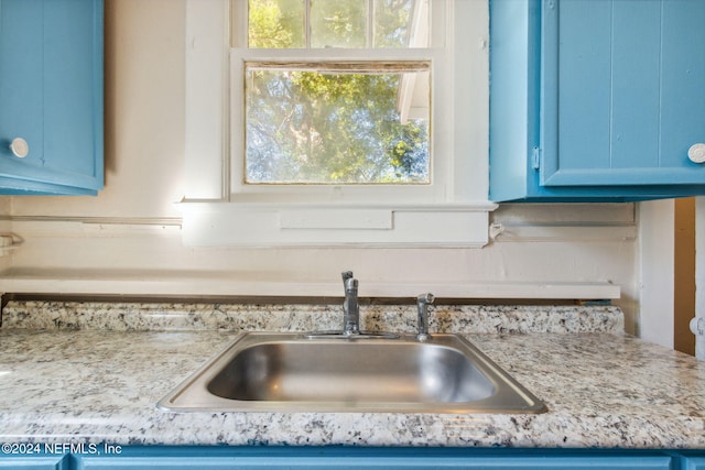 details with blue cabinets and sink