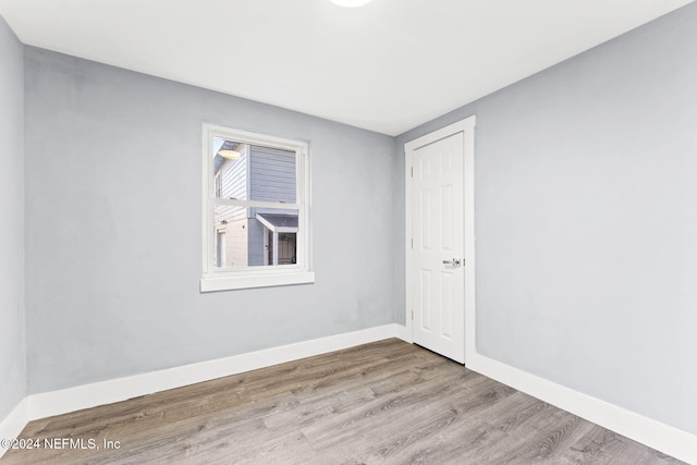 empty room with light hardwood / wood-style flooring