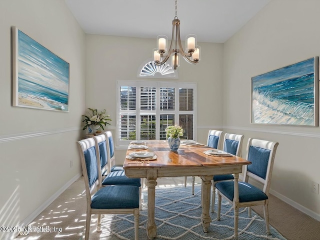 carpeted dining area with baseboards and an inviting chandelier