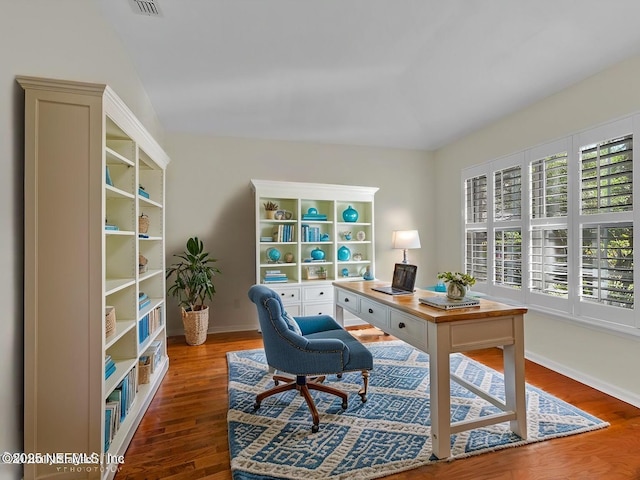 office area featuring visible vents, baseboards, and wood finished floors