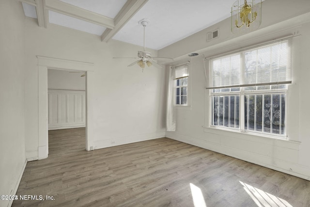 empty room featuring beam ceiling, ceiling fan with notable chandelier, and wood-type flooring