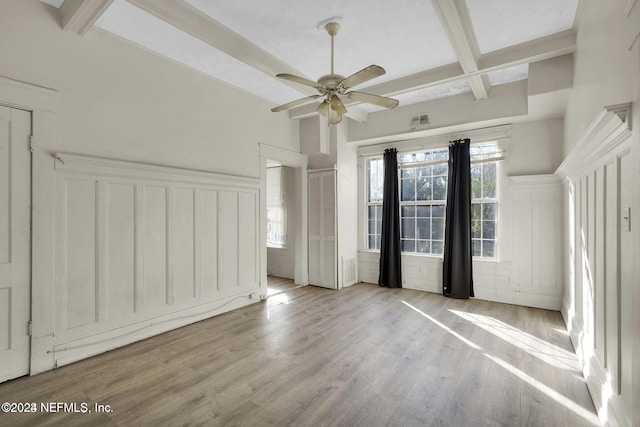 interior space with beam ceiling, ceiling fan, coffered ceiling, and light wood-type flooring