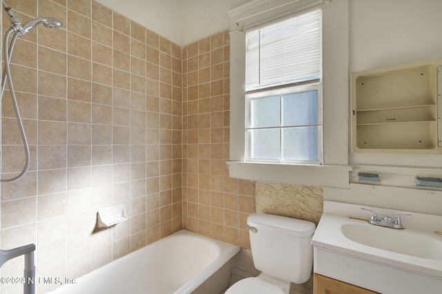 full bathroom with vanity, toilet, and tiled shower / bath