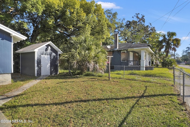 view of yard featuring a porch and a storage shed