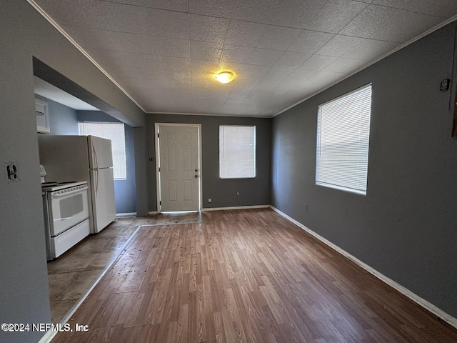 interior space featuring wood-type flooring and ornamental molding