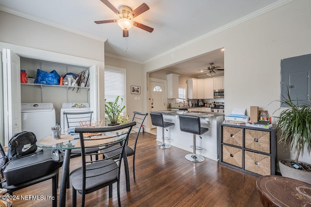 dining room featuring dark hardwood / wood-style floors, ceiling fan, ornamental molding, and washing machine and clothes dryer