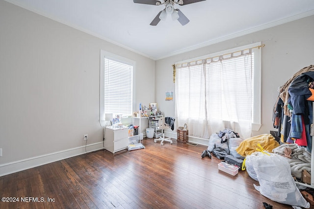 misc room with ceiling fan, crown molding, and dark wood-type flooring