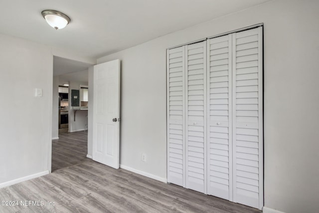 unfurnished bedroom with a closet and light hardwood / wood-style flooring