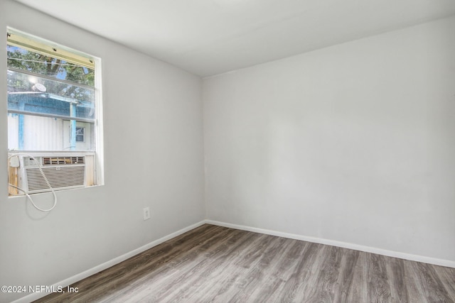 unfurnished room featuring hardwood / wood-style flooring and cooling unit