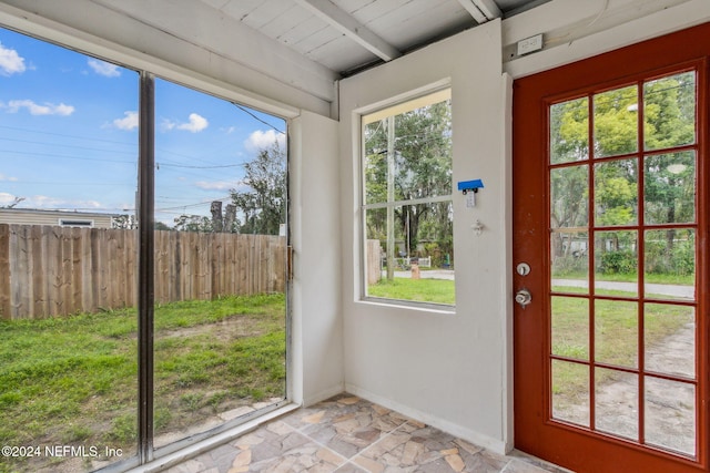 entryway featuring beamed ceiling, wooden ceiling, and a wealth of natural light