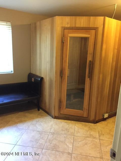 5375 Ortega Farms Blvd Unit 807, Jacksonville, FL 32210 - interior space featuring light tile patterned floors and wooden walls