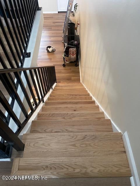 stairway featuring wood-type flooring