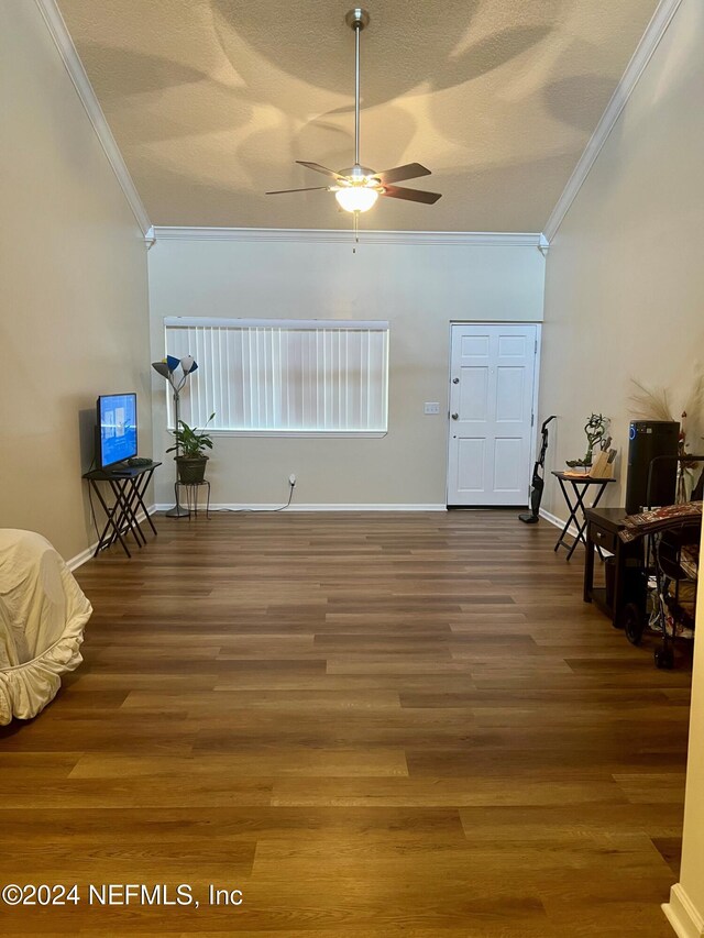 interior space with hardwood / wood-style floors, ceiling fan, and crown molding