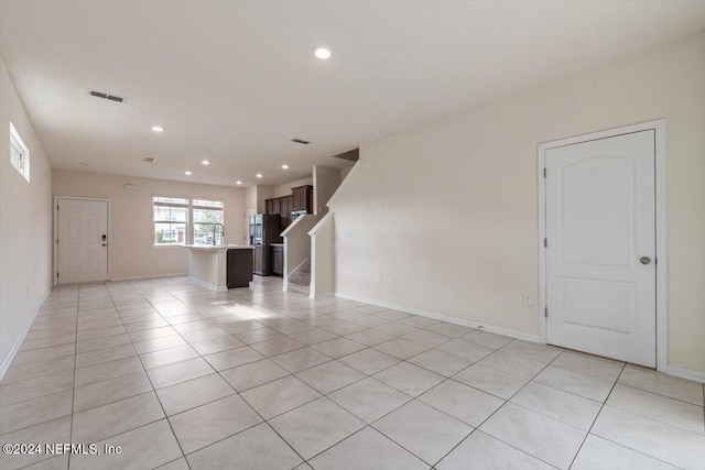 unfurnished living room with light tile patterned floors