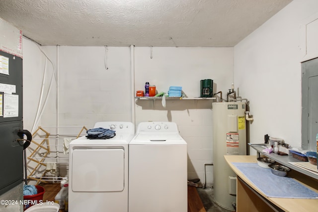 laundry room with washing machine and clothes dryer, electric water heater, and a textured ceiling