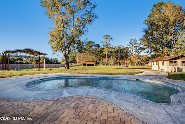 view of swimming pool with a yard and an outbuilding