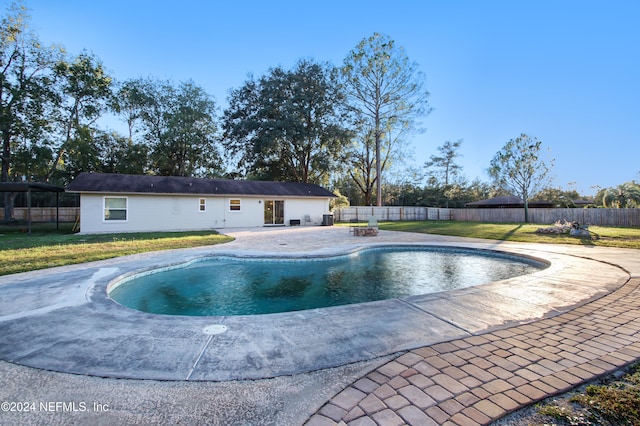 view of pool with a yard and a patio