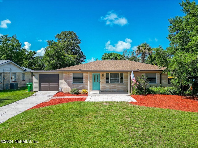 ranch-style home with central AC, a garage, and a front lawn