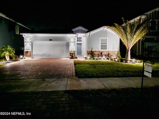 view of front of house with a lawn and a garage