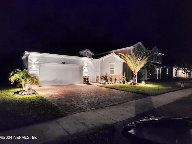 view of front facade with a garage and a lawn