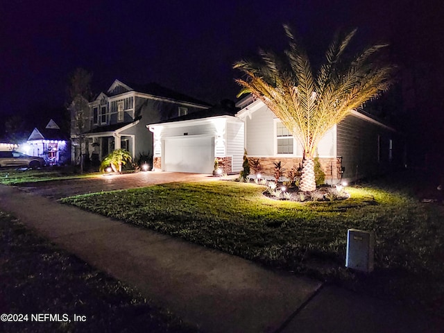 craftsman inspired home featuring a yard and a garage