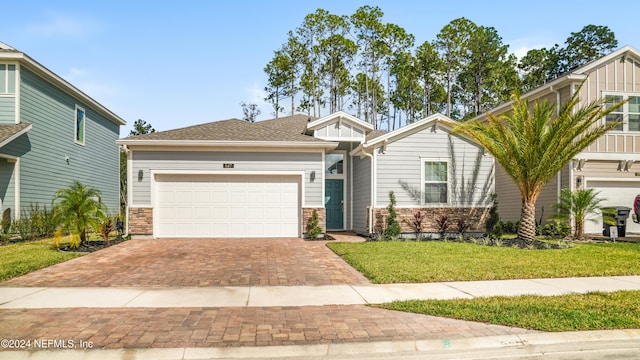 view of front of house featuring a front yard and a garage