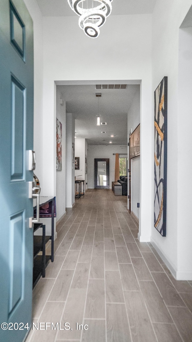 corridor featuring a notable chandelier