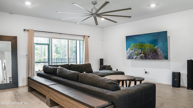 living room with light hardwood / wood-style flooring and ceiling fan