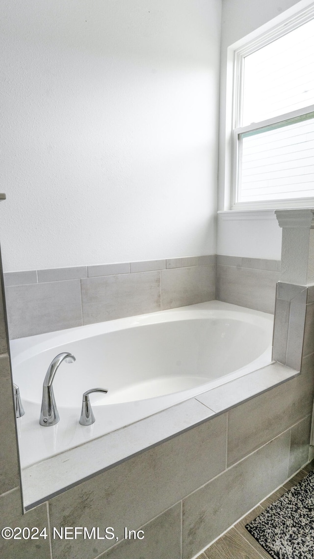 bathroom featuring tiled bath