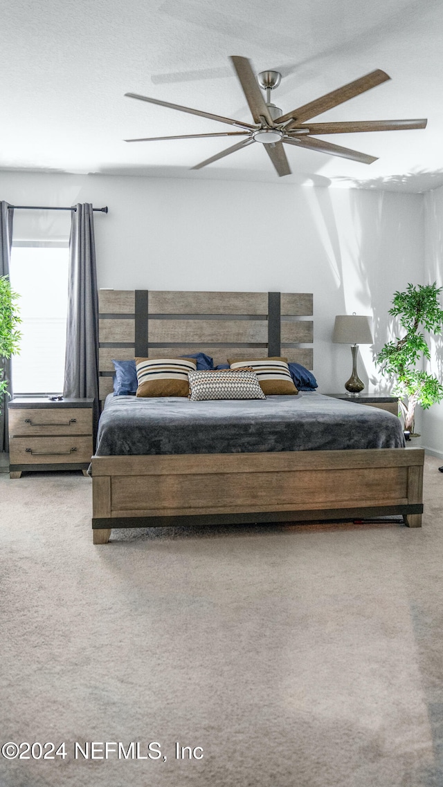 bedroom featuring ceiling fan and carpet floors