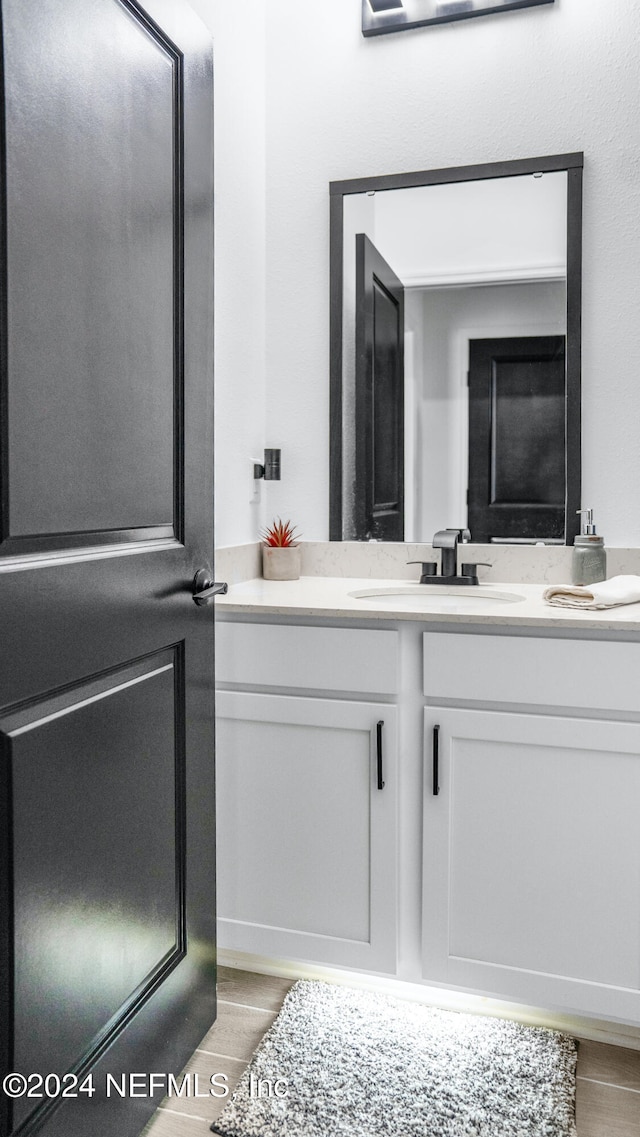 bathroom featuring hardwood / wood-style floors and vanity