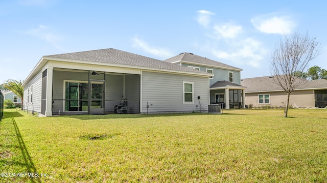 back of property featuring a yard, ceiling fan, and central air condition unit