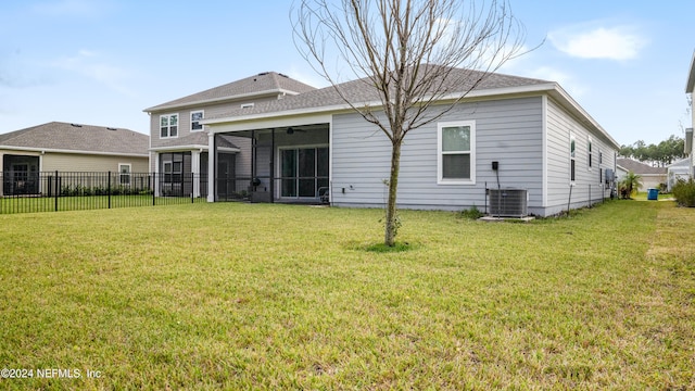 back of house featuring a yard, central AC, and a sunroom