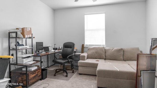 office space featuring light carpet and ceiling fan