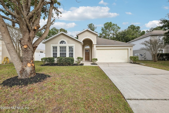 single story home featuring a garage and a front lawn