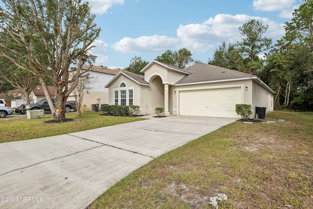 view of front of home with a garage and a front lawn