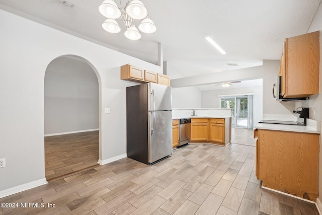 kitchen featuring ceiling fan with notable chandelier, light hardwood / wood-style floors, kitchen peninsula, and stainless steel appliances