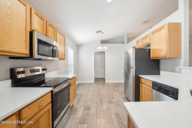 kitchen featuring stainless steel appliances, a notable chandelier, pendant lighting, lofted ceiling, and light wood-type flooring