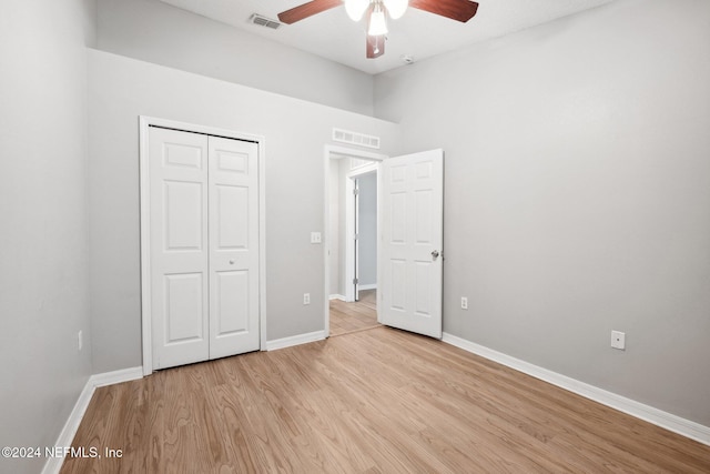 unfurnished bedroom with ceiling fan, a closet, and light hardwood / wood-style floors