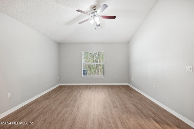 spare room with hardwood / wood-style floors, a textured ceiling, and ceiling fan